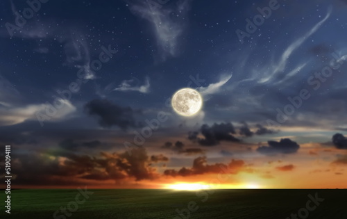 orange dramatic sunset on wild field sun down and moon rise on starry cloudy sky green grass nature landscape