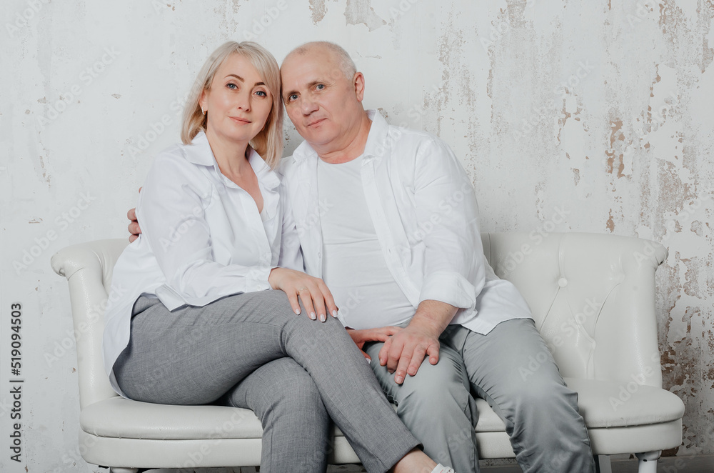 a man and his wife in white shirts in a photo studio