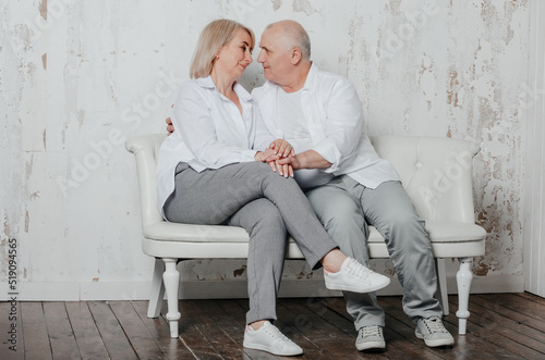 a man and his wife in white shirts in a photo studio photo