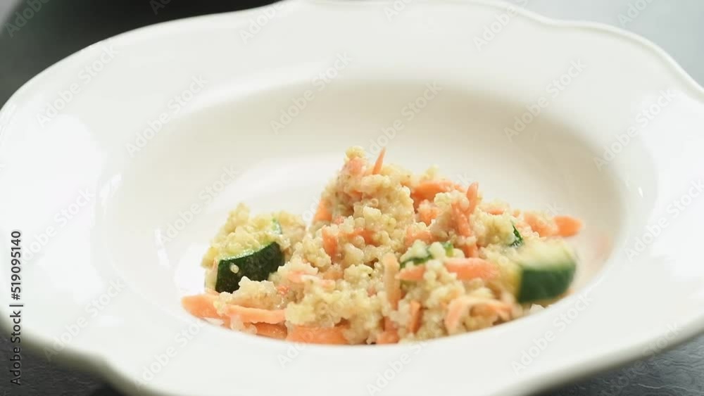 Serving quinoa salad with zucchini.
