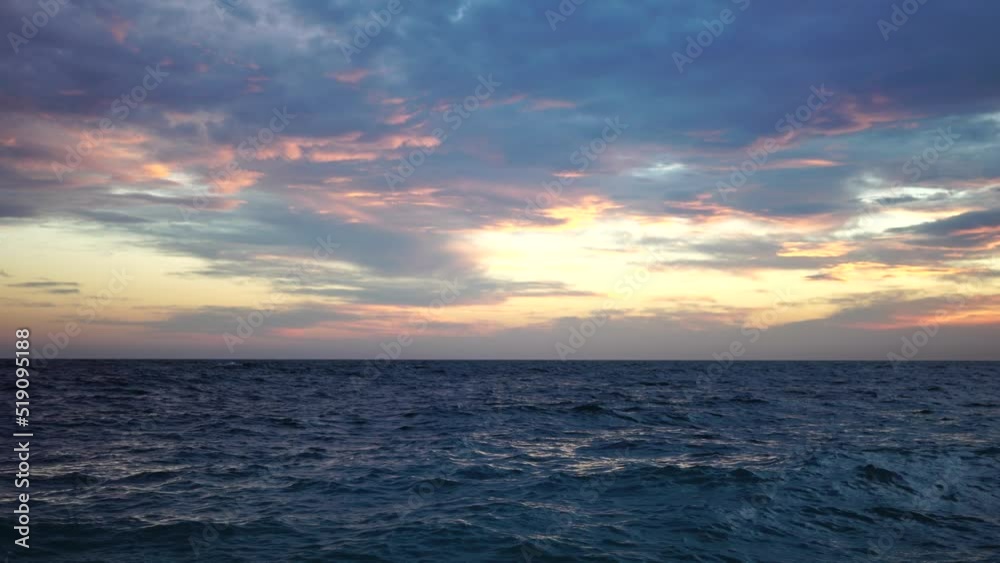 Dramatic Seascape over the beach during sunset, with rocky volcanic cliff is lit by the warm sunset. Evening sky with clouds. Nobody. The concept of calmness silence and unity with nature. Dramatic Seascape over the beach during sunset, with rocky volcanic cliff is lit by the warm sunset. Evening sky with clouds. Nobody. The concept of calmness silence and unity with nature.
