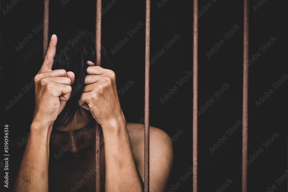 male inmate in prison lift hand to make a wish and pray on black ...