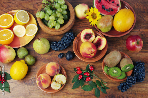 A variety of fresh ripe fruits on a wooden table.