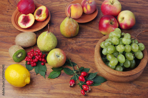Fototapeta Naklejka Na Ścianę i Meble -  A variety of fresh ripe fruits on a wooden table.