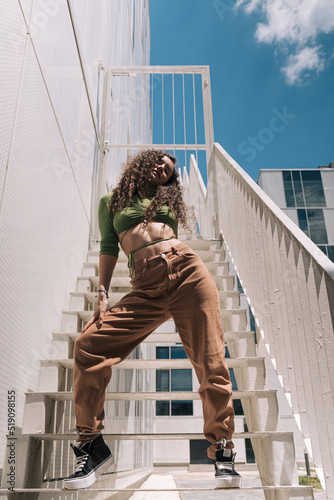 Young female dancer urban portrait on stairs of a modern building photo