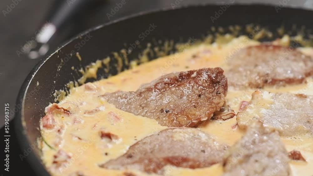 Preparing of delicious pork with sun-dried tomatoes in the frying pan. Chef putting pieces pork tenderloin in a frying pan.
Preparing of delicious pork with sun-dried tomatoes in the frying pan. Chef putting pieces pork tenderloin in a frying pan.