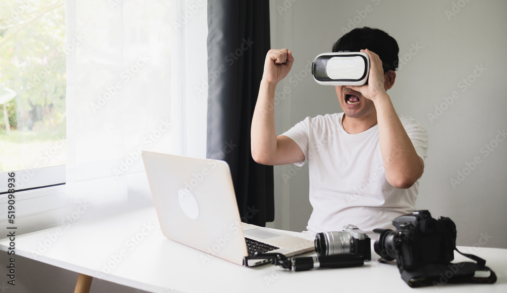 Concept Virtual Reality Technology, Asian male photographer. There is an emotional connection with the use of 3D VR glasses at home.
