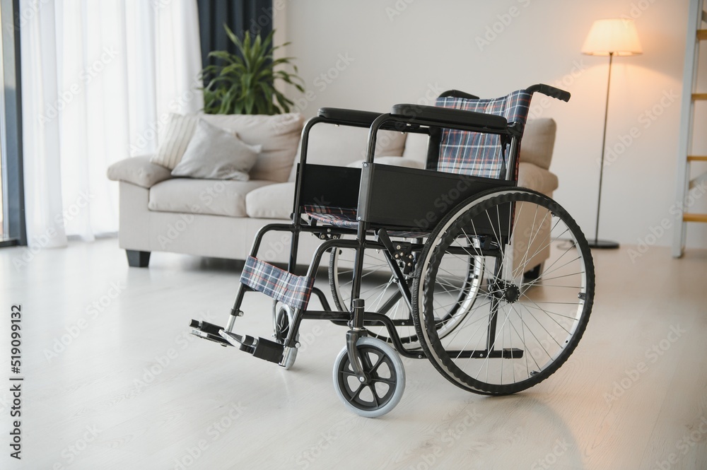 Empty wheelchair in the livingroom. Lonely and healthcare concept. Empty wheelchair in the livingroom. Lonely and healthcare concept.
