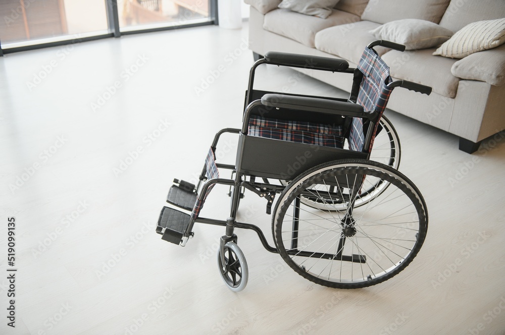 Empty wheelchair in the livingroom. Lonely and healthcare concept.