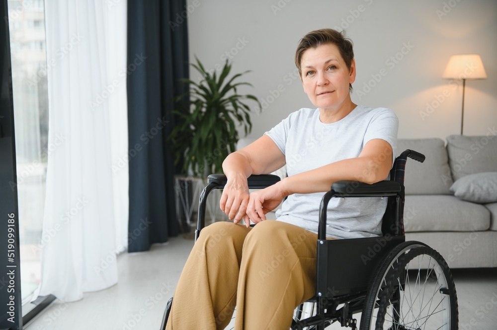 middle aged woman sitting on wheelchair middle aged woman sitting on wheelchair