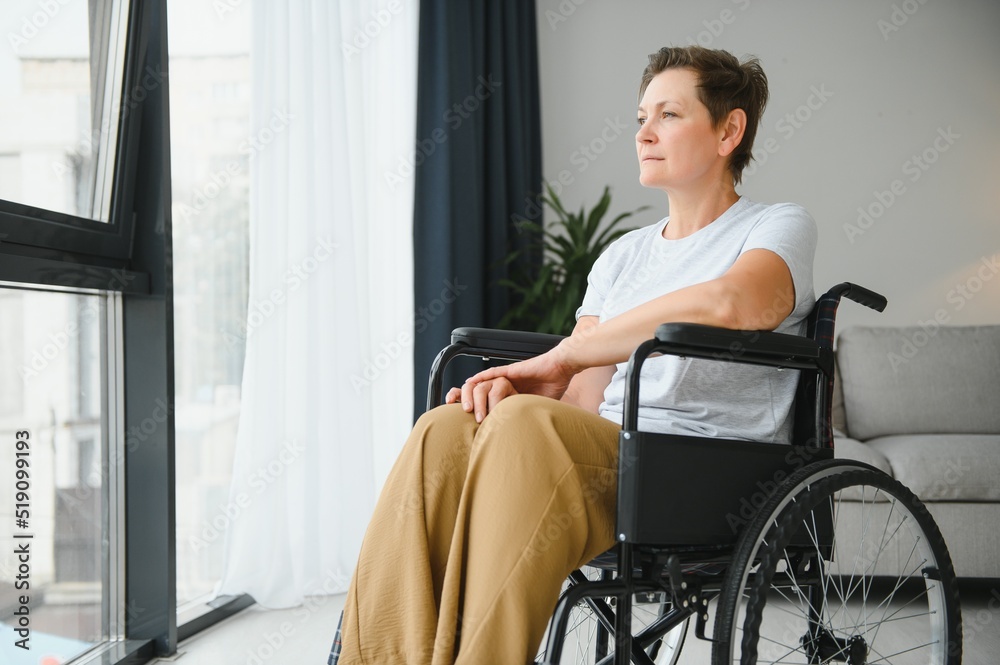 middle aged woman sitting on wheelchair middle aged woman sitting on wheelchair