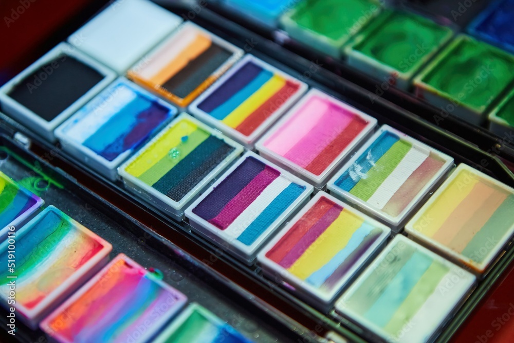 Paints for body art and drawing on the skin. Different colors for beautiful images. The view from the top. Paints for body art and drawing on the skin. Different colors for beautiful images. The view from the top.