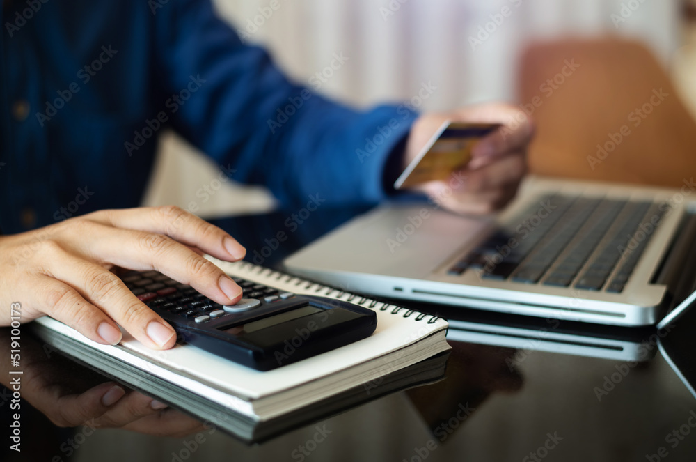 Businessman calculating monthly office expenses, taxes, bank account balance and credit card bills payment, Income is not enough for expenses in office. Businessman calculating monthly office expenses, taxes, bank account balance and credit card bills payment, Income is not enough for expenses in office.