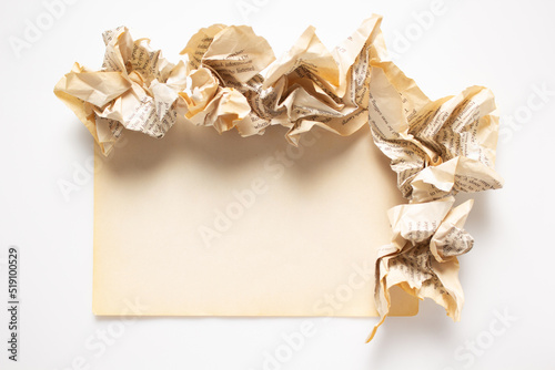 Aged paper and crumpled paper balls at isolated white background