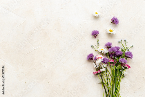 Bunch of wild meadow flowers and herbs chamomile, cornflower and ranunculus. Summer floral background