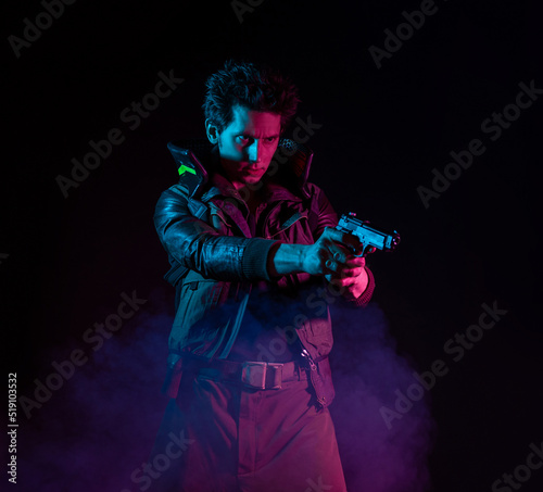 A guy in a cyberpunk image, aiming a gun at someone. a futuristic character. A young man in neon lighting on a black background