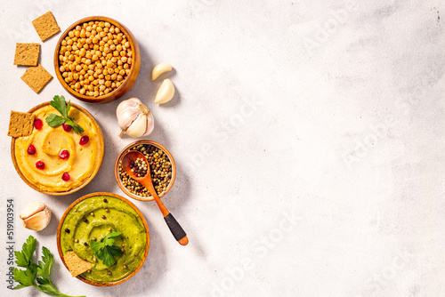 Flatlay of vegetarian hummus in bowls with chickpeas