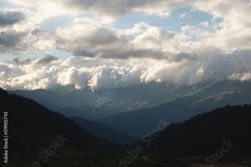 Mountain forest gorge landscape, clouds cling to the tops of high mountains, a glimpse of the sun's rays © yanik88