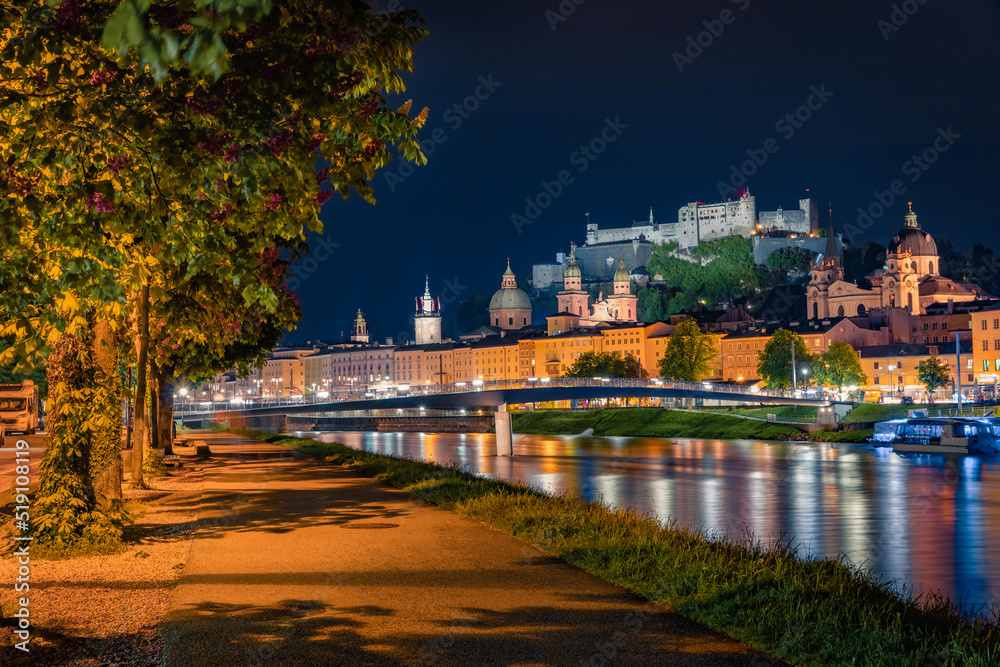 Wonderful summer view of Old town of Salzburg. Illuminated cityscape of Salzburg with Hohensalzburg Castle on background, Austria, Europe. Traveling concept background.