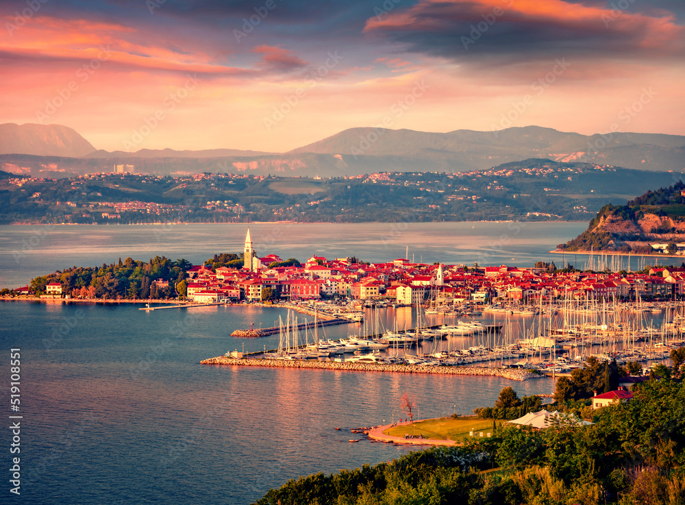 Bird's eye view of old fishing port Izola with many luxury yachts. Exciting summer seascape of Adriatic Sea, Slovenia, Europe. Beauty of countryside concept background.