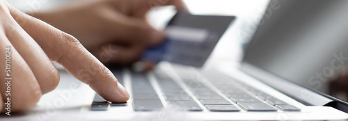 Asian girls use credit cards to shop online with a coffee cup and laptop on the table, Buy online, Shopping Online concept.