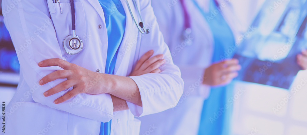 Close up shoot of doctor's crossed hands and colleague with x-ray on the background. Close up shoot of doctor's crossed hands and colleague with x-ray on the background.