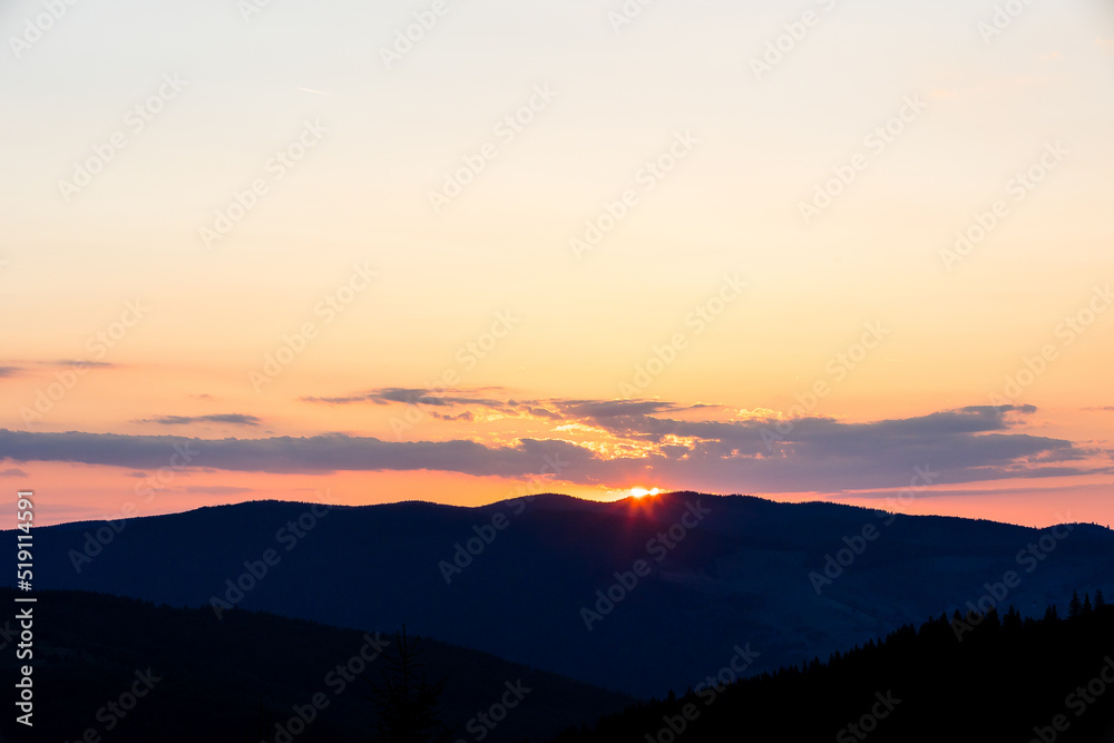 Beautiful sunset landscape with mountains and trees