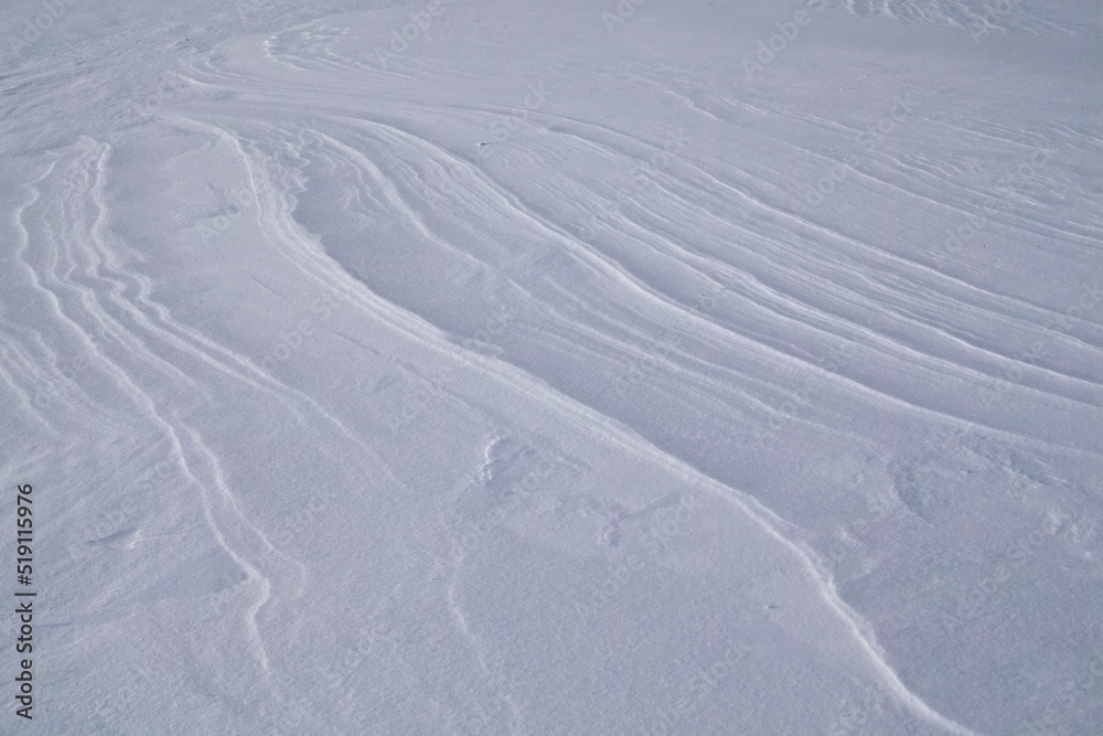 Winter scene with snow patterns on ground in cold winter weather. Winter scene with snow patterns on ground in cold winter weather.