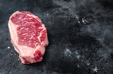 Raw Striploin steak, beef butchery cut. Black background. Top view. Copy space