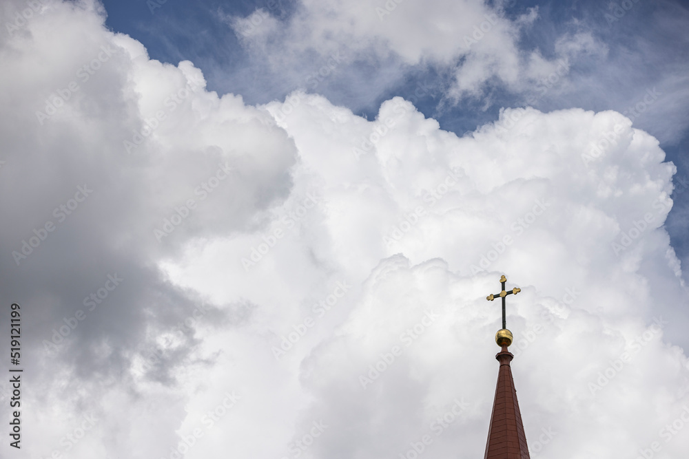 Tower of the roof of a lutheran church with a cross on the very top