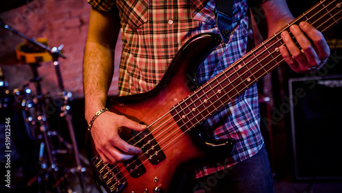 Detail man hands play an acoustic guitar live rock band