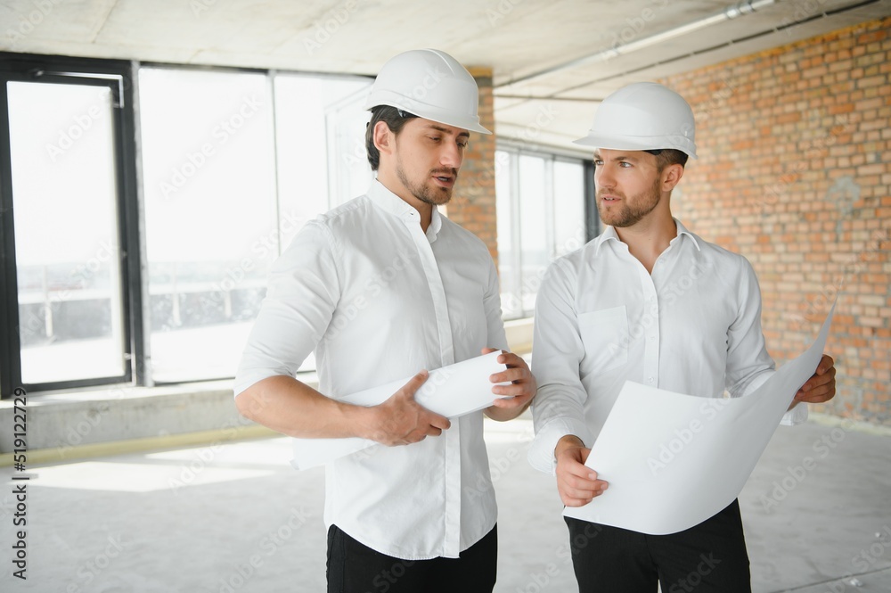 Two young man architect on a building construction site Two young man architect on a building construction site