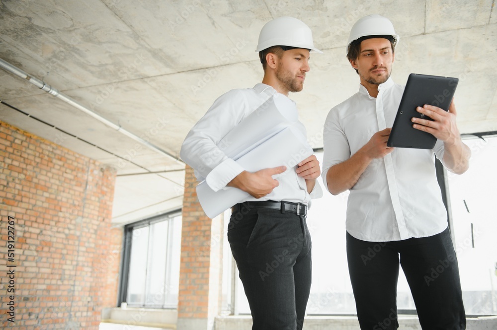 Two young man architect on a building construction site Two young man architect on a building construction site