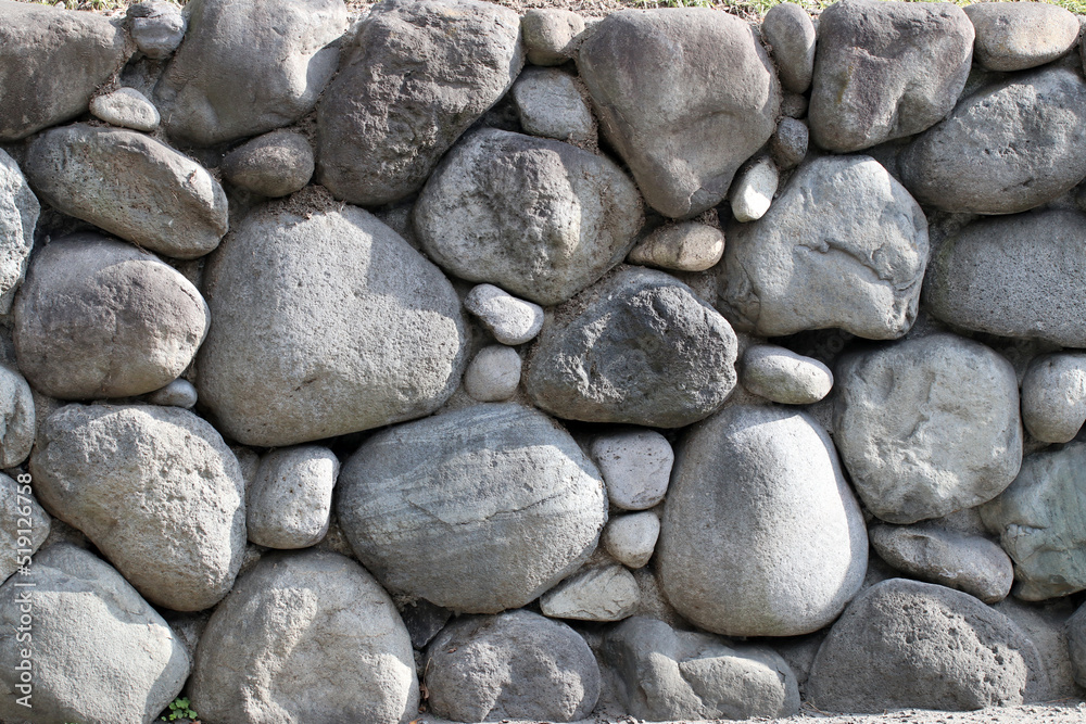 Japanese round rock Masonry texture.丸い石を積み上げた石積みの壁。 Japanese round rock Masonry texture.丸い石を積み上げた石積みの壁。