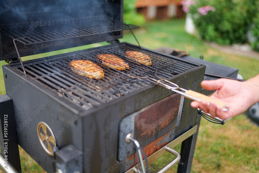 grilled salmon steaks are coking on the firewood, in the backyard. High-quality photo grilled salmon steaks are coking on the firewood, in the backyard. High-quality photo