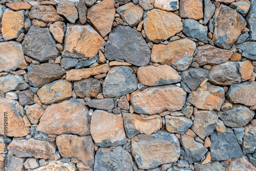 Textura de pared de piedra volcánica natural antigua, con diferentes colores Textura de pared de piedra volcánica natural antigua, con diferentes colores