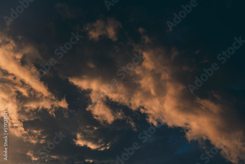 Beautiful evening sky with multi-colored bright clouds. Rain clouds at sunset. High-quality photo