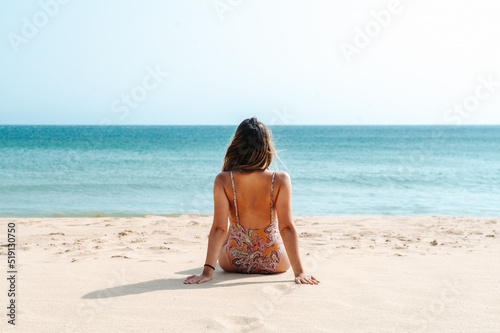 Canvas Print Unrecognizable woman in swimwear observing sea