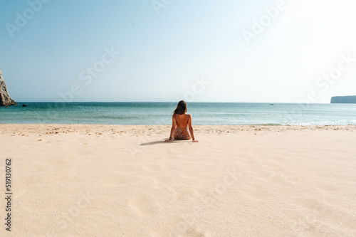Unrecognizable woman in swimwear observing sea
