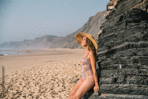 Woman near rock on seashore
