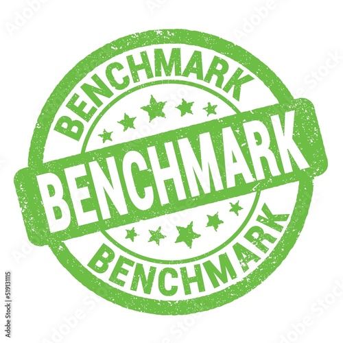 BENCHMARK text written on green round stamp sign.