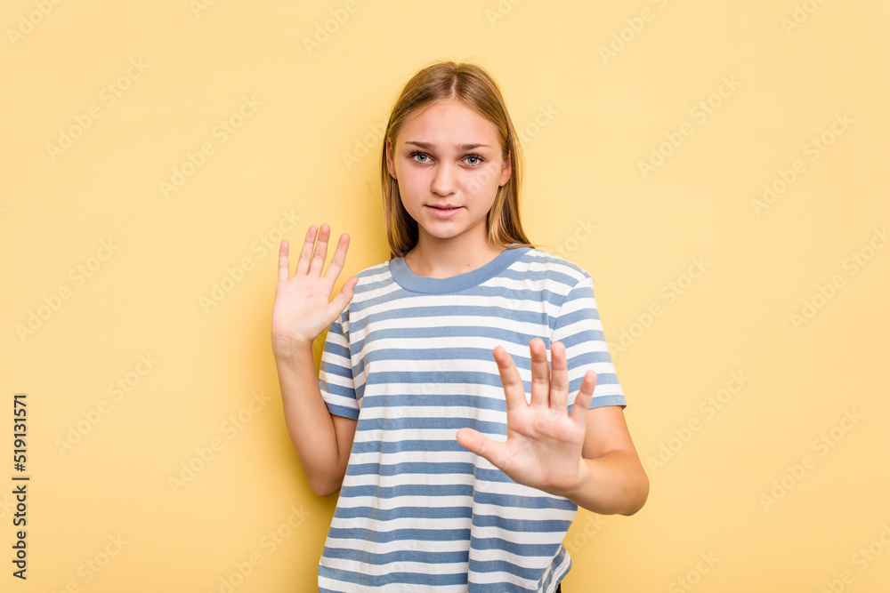 Young caucasian girl isolated on yellow background being shocked due to an imminent danger Young caucasian girl isolated on yellow background being shocked due to an imminent danger