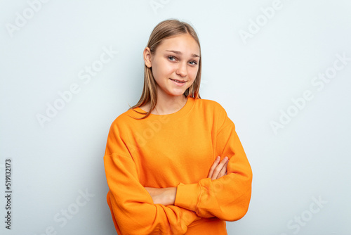 Young caucasian girl isolated on blue background happy, smiling and cheerful.