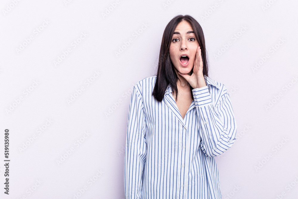 Young caucasian woman isolated on pink background shouts loud, keeps eyes opened and hands tense. Young caucasian woman isolated on pink background shouts loud, keeps eyes opened and hands tense.