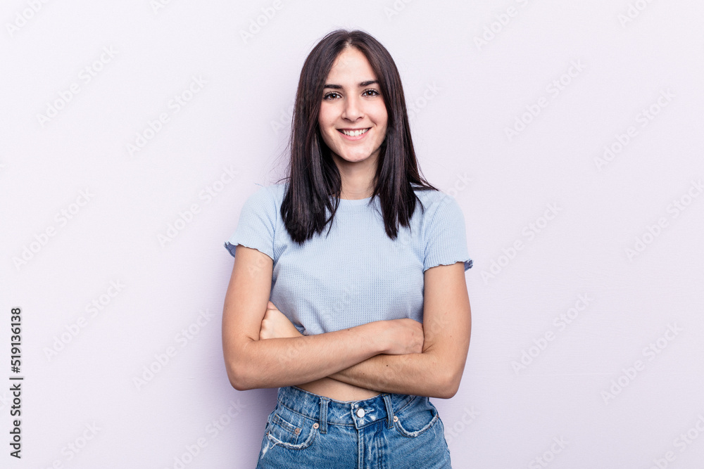 Obraz premium Young caucasian woman isolated on pink background who feels confident, crossing arms with determination.