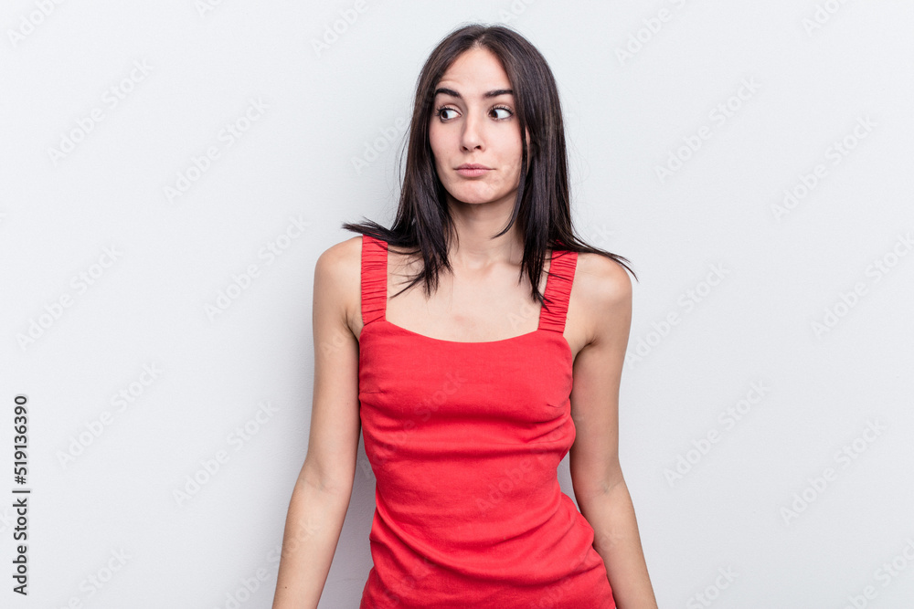 Young caucasian woman isolated on white background shrugs shoulders and open eyes confused. Young caucasian woman isolated on white background shrugs shoulders and open eyes confused.