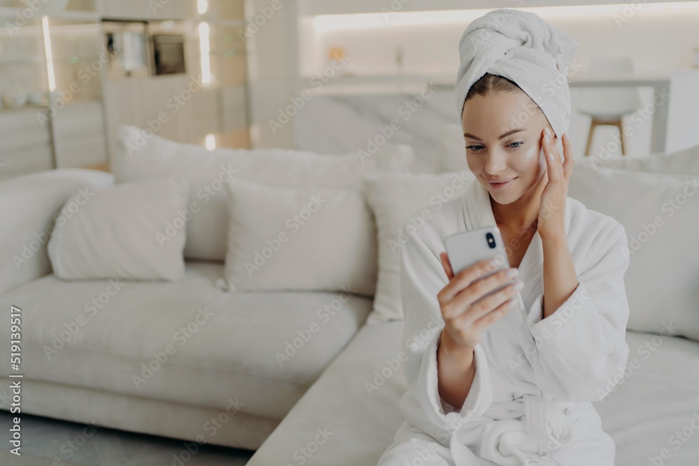 Woman beauty blogger creating video on smartphone for her vlog about daily skincare routine Woman beauty blogger creating video on smartphone for her vlog about daily skincare routine