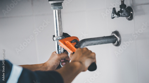 plumber at work in a bathroom, plumbing repair service, assemble