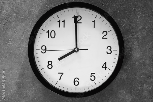 Classic black and white analog clock blue background