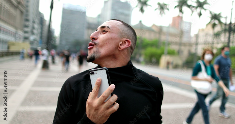 Happy hispanic man dancing in street. Excited latin guy dances in joy Happy hispanic man dancing in street. Excited latin guy dances in joy